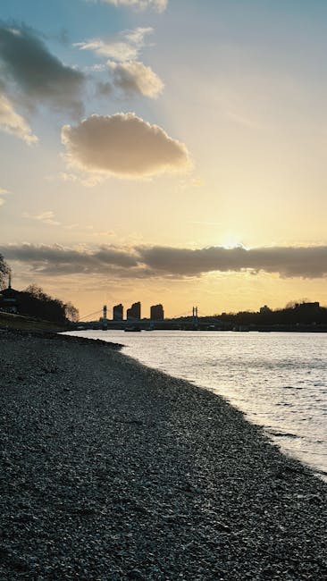 Close-up view of the suspension cables and ornate towers of Hammersmith Bridge against a partly cloudy sky during daytime, with a focus on the structural details and weathered metal surfaces of the historic bridge, highlighting its architectural features without any cleaning tools or surfaces visible, as would be relevant for discussing maintenance or inspection processes related to surface cleaning or preservation by Hammersmith Carpet Cleaning.